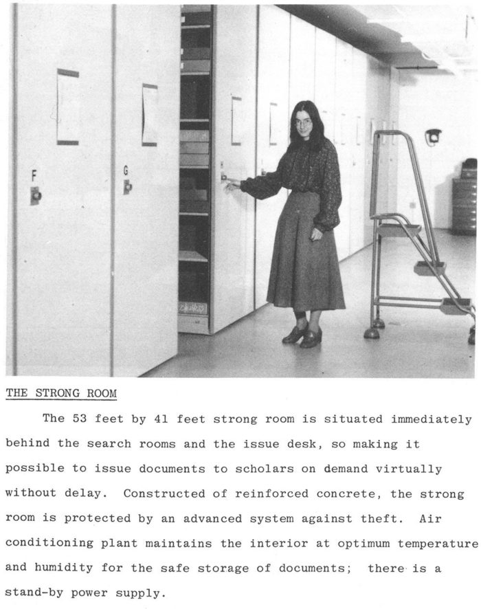 A black and white photograph of an archivist pointing at the rolling stacks. Underneath the photo is a description of the Strong Room: "The 53 feet by 41 feet strong room is situated immediately behind the search rooms and the issue desk, so making it possible to issue documents to scholars on demand virtually without delay.  Constructed from reinforced concrete, the strong room is protected by an advanced system against theft. Air conditioning  plant maintains the interior at optimum temperature and humidity for safe storage of documents; there is standby power supply."