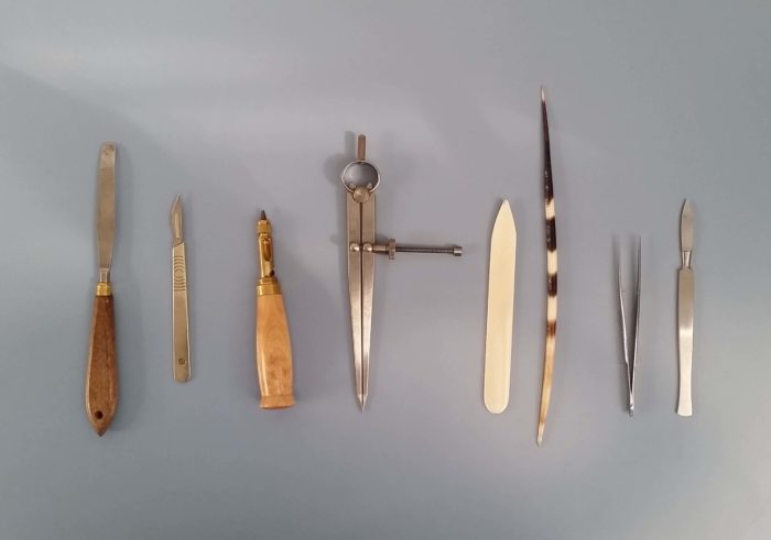 A row of hand tools laid out on a table