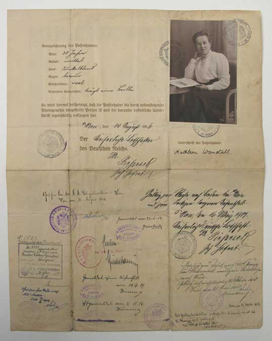 A passport with a black and white photograph and traveller details for Kathleen Wanstall