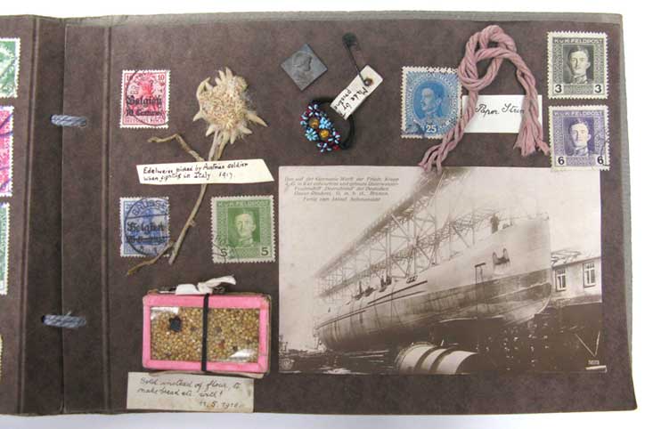 A page from Kathleen Wanstall's scrapbook with a photograph, postage stamps, a pressed edelwiess flower and other ephemera