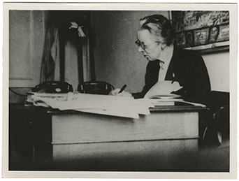Mary Agnes Hamilton writing at her desk