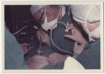 Patrick Steptoe and medical team performing a laprascopy in an operating theatre. 