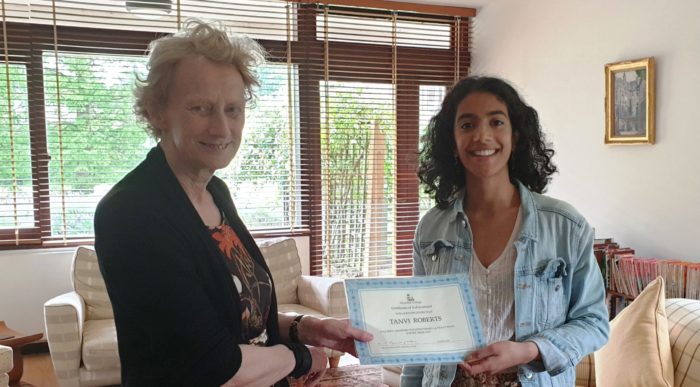Athene Donald handing a certificate to Tanvi Roberts