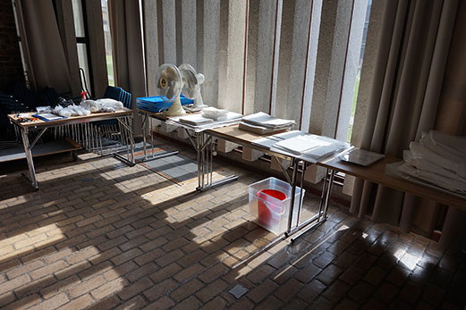 Tables set up in the Jock Colville Hall with disaster response supplies laid out