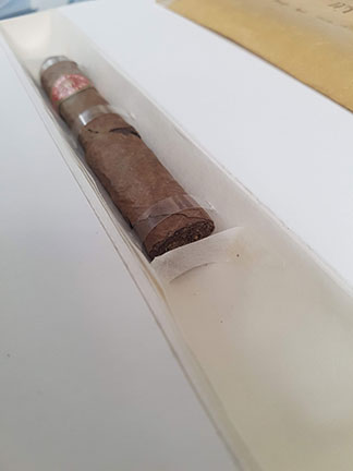 Photo of the cigar sitting in its housing. It is held in place with strips of clear EVA-con over the top, and Japanese paper at each end.