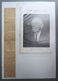 An A4 page from the original scrapbook, onto which has been mounted a newspaper clipping and a leaflet in a plastic wallet