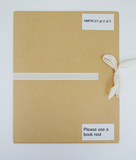 A 4 flap cardboard folder tied with a ribbon.