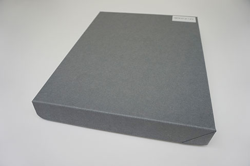 A rectangular grey clamshell cardboard box