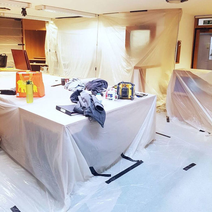 The reading room in the Archives Centre during the refurbishment. The floor, desks, shelves and most of the walls are covered in plastic sheeting.