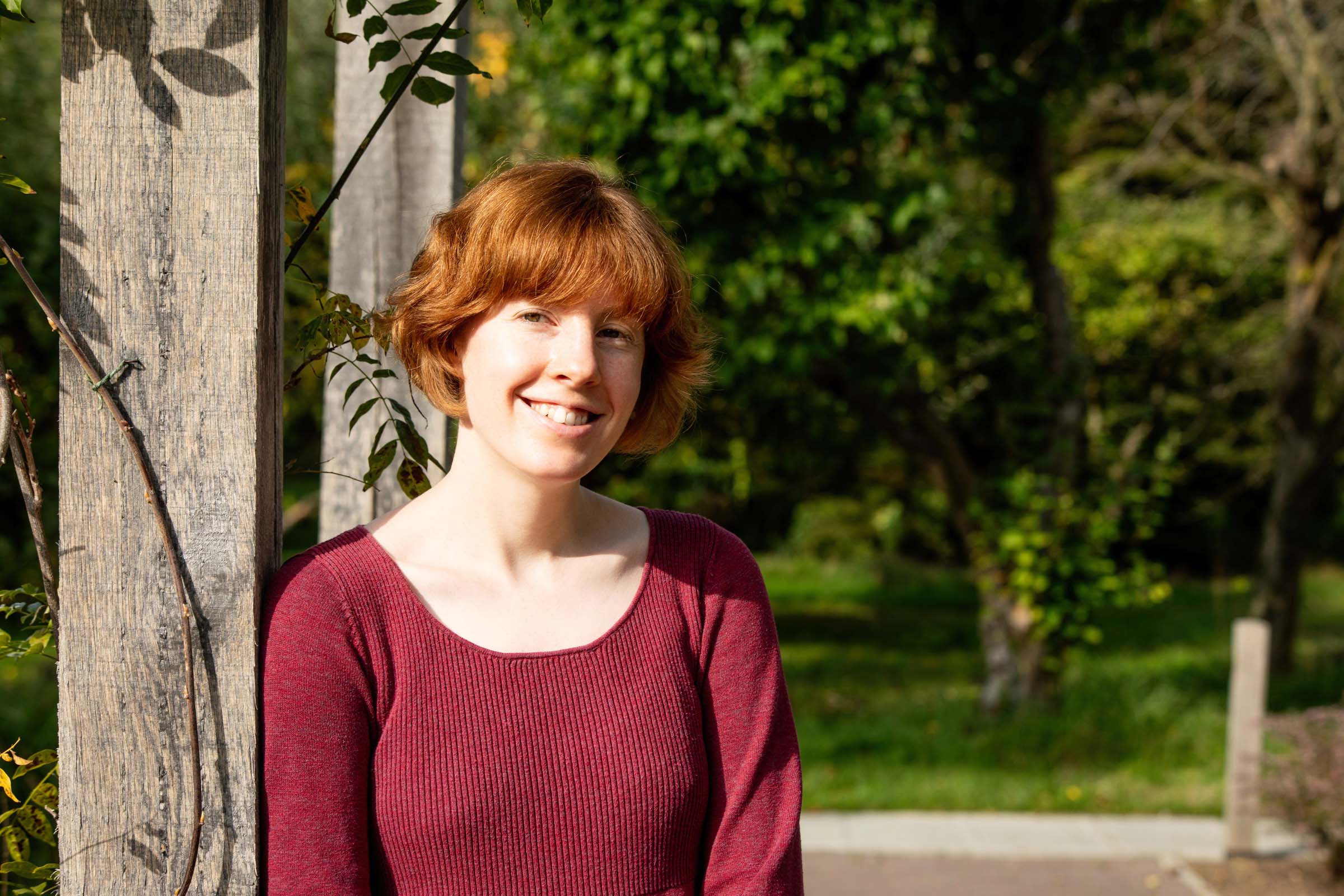 College Librarian Annie Gleeson in the Xiaotian Fu Garden, smiling into the camera