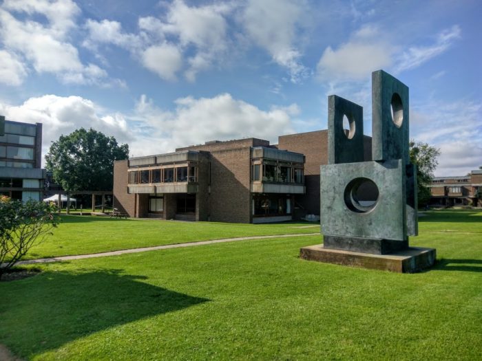 Exterior view of the College Library, with the Barbara Hepworth sculpture 'Four Square Walk Through' in the foreground..