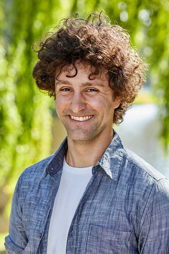 Profile photo of Jon Roozenbeek. He is standing outside and smiling at the camera