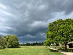 Sports fields under dark clouds