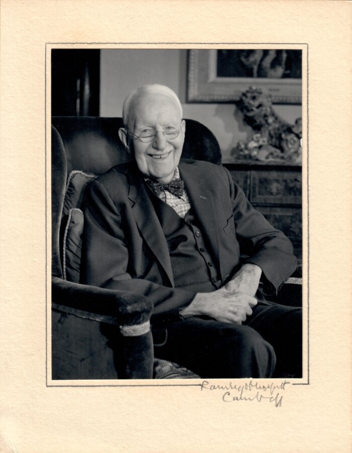Black and white portrait photograph of A V Hill, sitting in an armchair