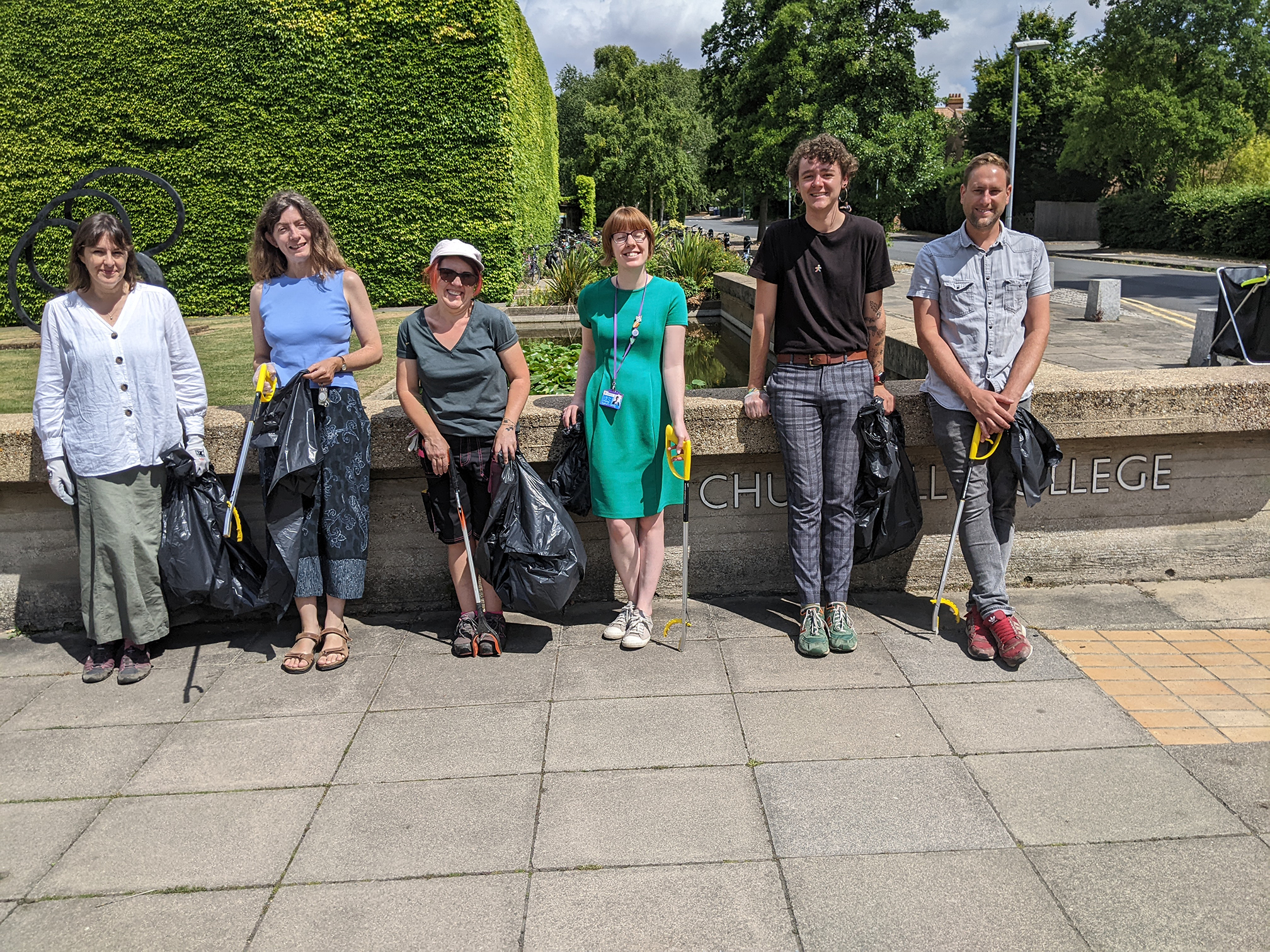 A group of people with bin bags about to go on a litter pick