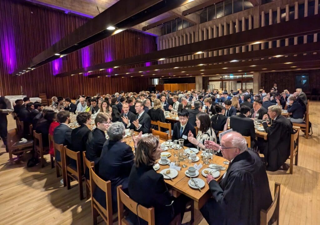 Groups of people seated socialising in the Dining Hall