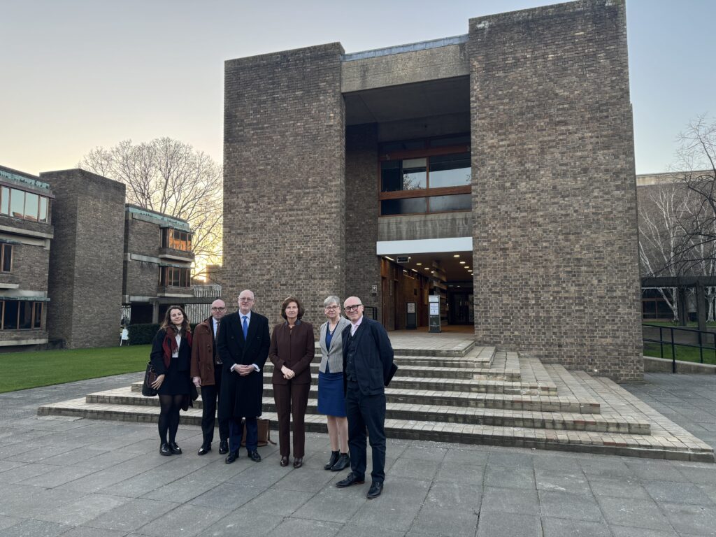 A group of people in front of the College steps